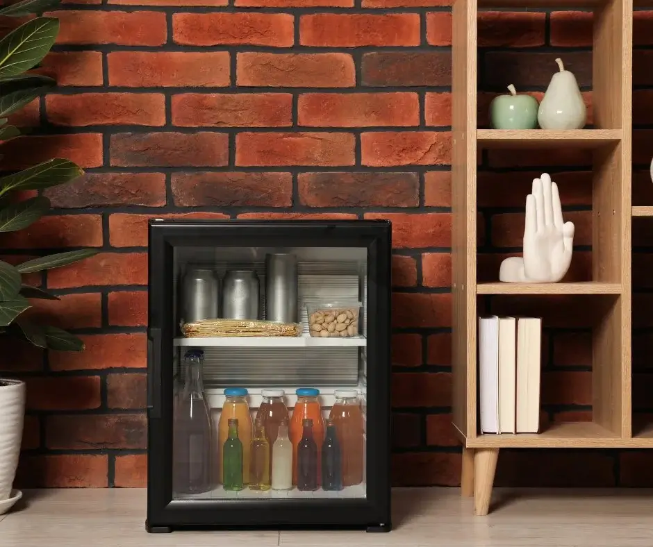 Modern hotel minibar stocked with non-alcoholic drinks and light snacks, illustrating the Zero Proof trend in hospitality.