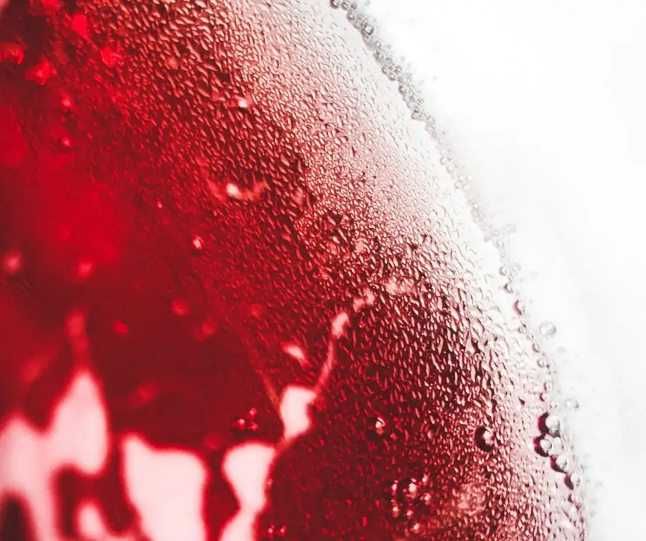 Close-up of a zero proof drink texture on glass, highlighting structure, density, and complexity rather than juice-like sweetness